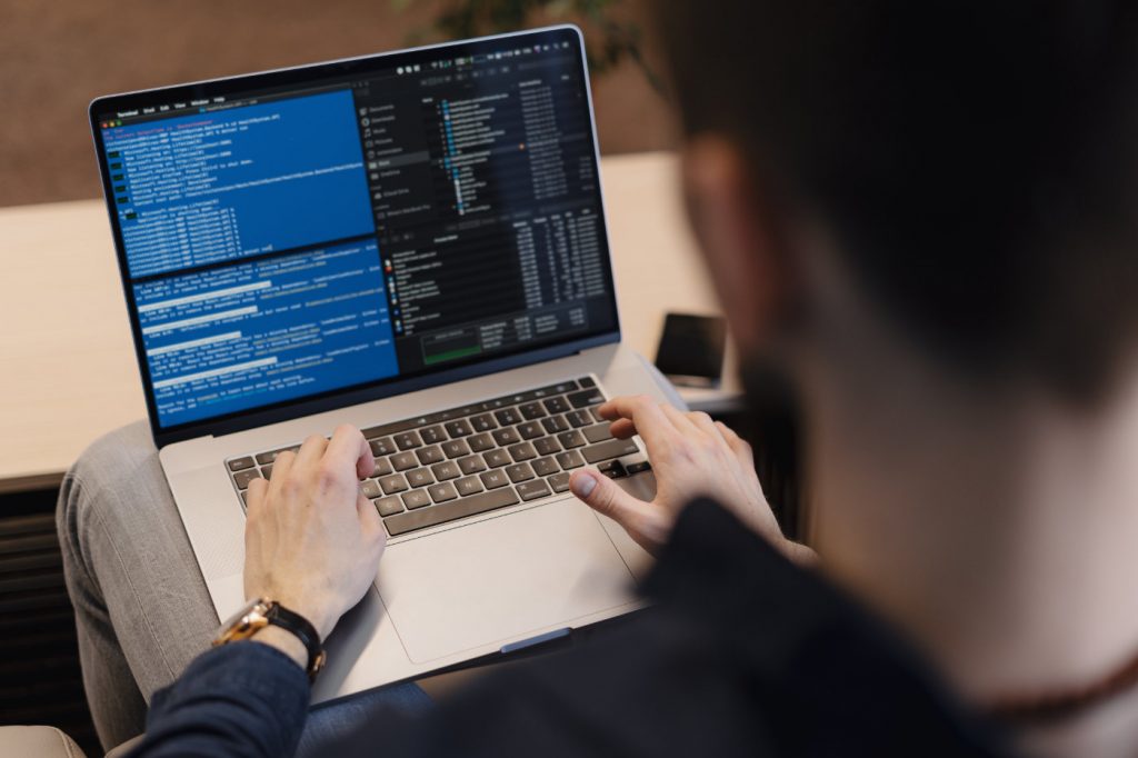 Man working on computer. Young it worker using laptop in the office, Internet marketing, technology, finance, business concept